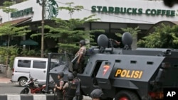 A police armored vehicle is parked outside a Starbucks cafe after an explosion in Jakarta, Indonesia, Jan. 14, 2016. 