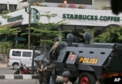 A police armored vehicle is parked outside a Starbucks cafe after an explosion in Jakarta, Indonesia, Jan. 14, 2016.