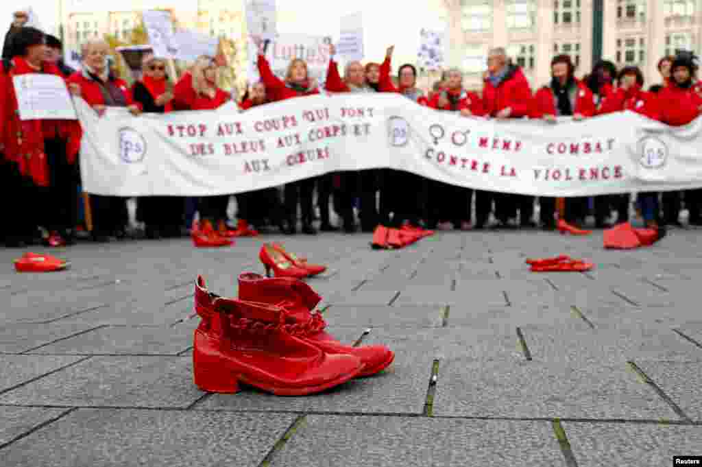 Red shoes are placed on the ground during a demonstration against all kinds of violence towards women in central Brussels, Belgium.