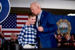 FILE - Democratic presidential candidate Joe Biden kisses Brayden Harrington, 12, at a campaign stop Feb. 10, 2020, in Gilford, N.H. Biden and Harrington talked about their struggle with stuttering.