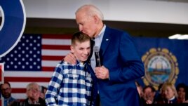 FILE - Democratic presidential candidate Joe Biden kisses Brayden Harrington, 12, at a campaign stop Feb. 10, 2020, in Gilford, N.H. Biden and Harrington talked about their struggle with stuttering.