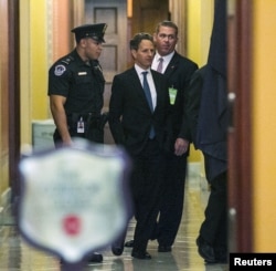 U.S. Treasury Secretary Timothy Geithner (C) walks through a U.S. Capitol hallway before meeting with Senate Minority Leader Mitch McConnell (R-KY) in Washington, D.C., November 29, 2012.