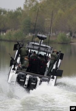 FILE - Texas state troopers speed toward a park in Reynosa, Mexico, as they head out on patrol along the Rio Grande from Anzalduas Park in Mission, Texas, Jan. 6, 2016.