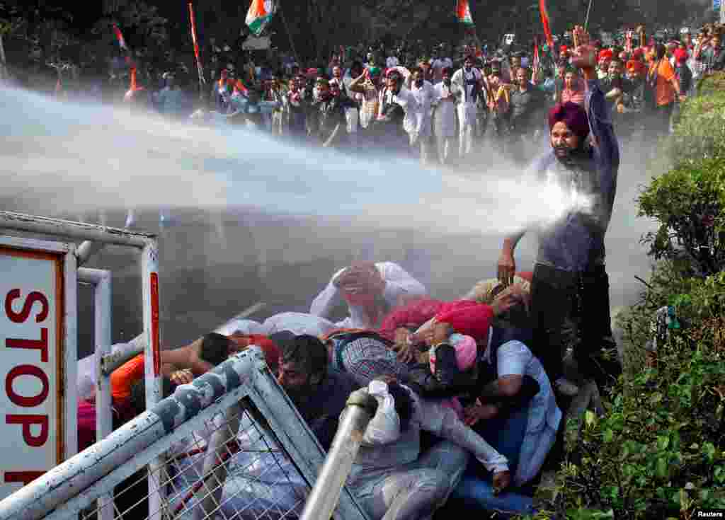 A demonstrator is hit by a water cannon used by police during a protest against what they say is state government&rsquo;s failure to arrest those involved in the sacrilege of Guru Granth Sahib, the religious book of Sikhs, in Behbal Kalan village of Punjab in 2015, in Chandigarh, India, Oct. 26, 2016.