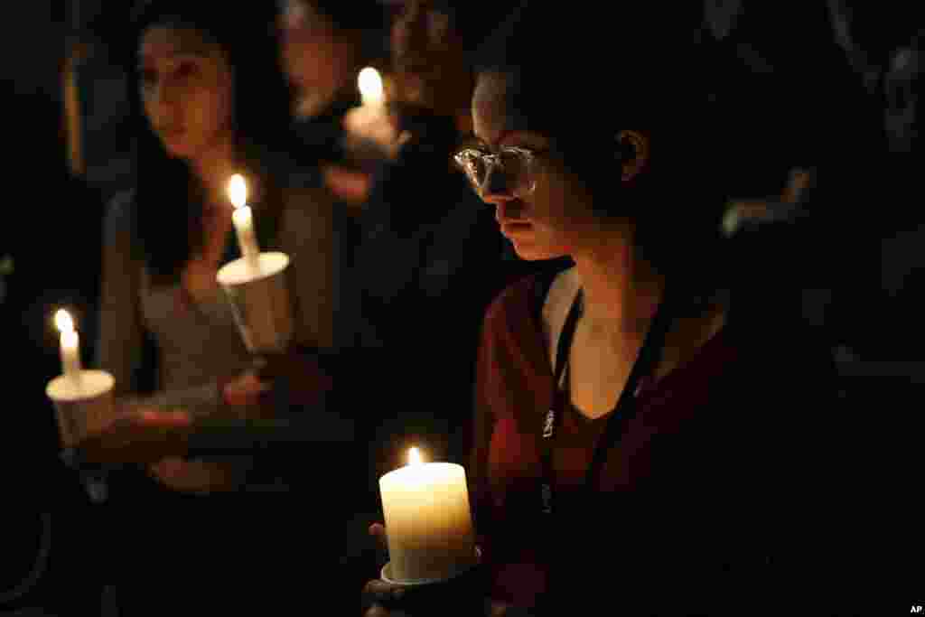 Natalynn Rivis, a student at University of Nevada Las Vegas, right, takes part in a vigil Monday, Oct. 2, 2017, in Las Vegas, Nevada.
