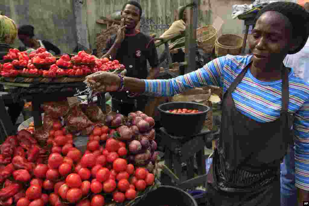 NIGERIA: Strikes by labor unions protesting high gasoline prices caused damage to fresh produce inventories. A woman sells tomatoes at a market in Obalende, Lagos, Nigeria, Saturday, Jan. 14, 2012.&nbsp;