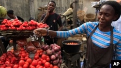 Women sells tomatoes at a market in Obalende, Lagos, Nigeria, Saturday, Jan. 14, 2012. 