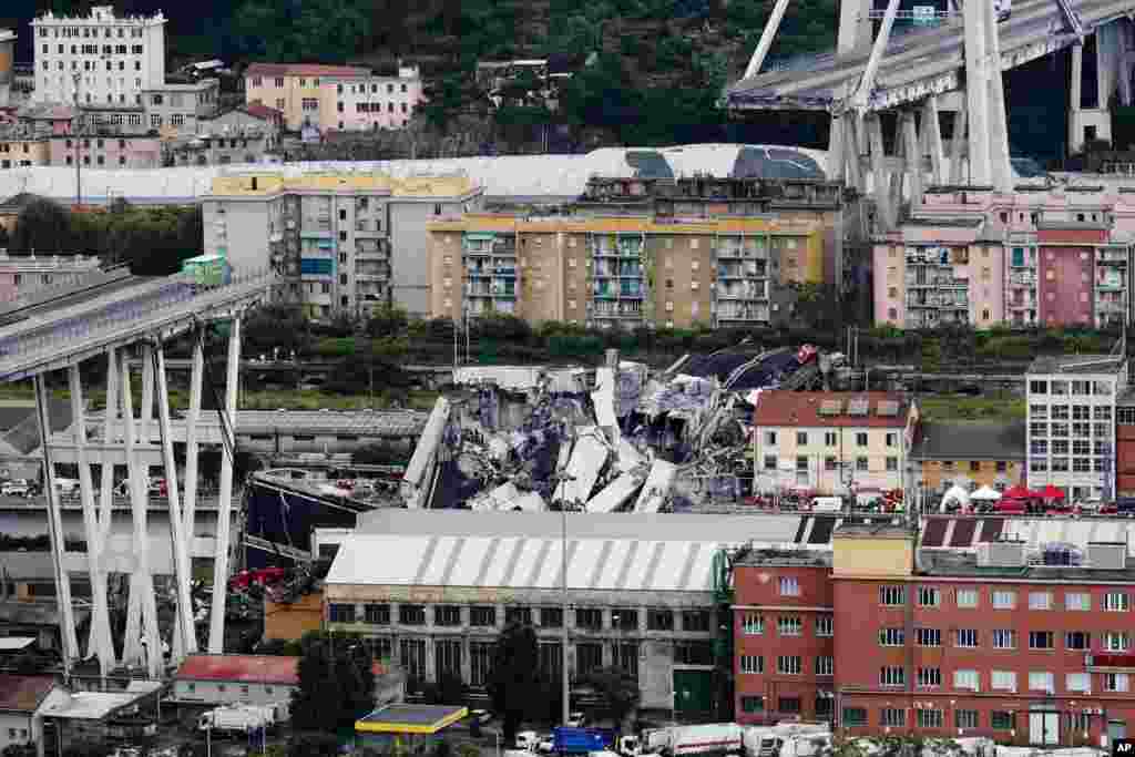 Cars are blocked on the Morandi highway bridge after a large section of it collapsed in Genoa, Italy, Aug. 14, 2018, during a sudden and violent storm, sending vehicles plunging 90 meters (nearly 300 feet) into a heap of rubble below.