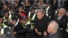FILE - Cardinal George Pell, center right, is surrounded by police as he arrives at the Melbourne Magistrates Court in Melbourne, Australia, July 26, 2017. 