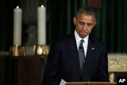 FILE - President Barack Obama pauses while delivering the eulogy in honor of former Delaware Attorney General Beau Biden at St. Anthony of Padua Church in Wilmington, Delaware, June 6, 2015.