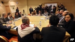The Yemeni Houthi rebel delegation, background, and delegates of the internationally recognized Yemeni government, foreground, meet for a second day for talks on implementing a prisoner exchange agreed to in Sweden last month, in Amman, Jordan, Thursday, Jan. 17, 2019. 