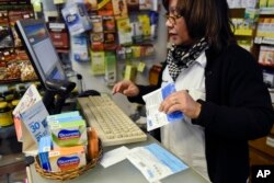 A pharmacy employee registers the sale of two bags of legal marijuana for a customer in Montevideo, Uruguay, July 19, 2017.