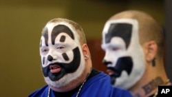 FILE - Joseph Bruce, aka Violent J, left, and Joseph Utsler, aka Shaggy 2 Dope, members of the Insane Clown Posse, address the media in Detroit. The rap metal group sued the U.S. Justice Department over a 2011 FBI report that describes the duo's devoted fans, the Juggalos, as a dangerous gang, saying the designation has tarnished their fans' reputations and hurt business.