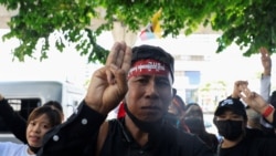 A Myanmar citizen shows a three-finger salute representing resistance to the military junta at a protest against the execution of pro-democracy activists at Myanmar's embassy in Bangkok, Thailand, on July 26, 2022. (Soe Zeya Tun/Reuters)