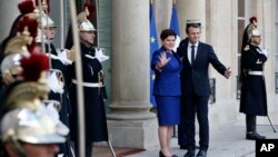 France's President Emmanuel Macron welcomes Polish Prime Minister Beata Szydlo, center left, prior to a meeting, at the Elysee Palace, in Paris, Nov. 23, 2017.