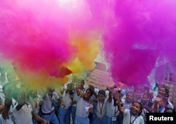 School children light fireworks as they celebrate India’s Satellite Launch Vehicle's take off which carried 104 satellites in a single mission, at a school in Ahmedabad, India, Feb. 15, 2017.