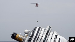 An Italian firefighter is lowered from a helicopter onto the grounded cruise ship Costa Concordia off the Tuscan island of Giglio, Italy, January 31, 2012.