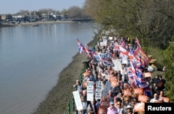 Pro-Brexit protesters take part in the March to Leave demonstration, as they walk along the River Thames, in London, Britain, March 29, 2019.