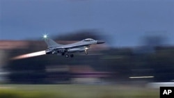 A Danish F-16 fighter-bomber takes off from the NATO airbase in Sigonella, Italy, March 21, 2011