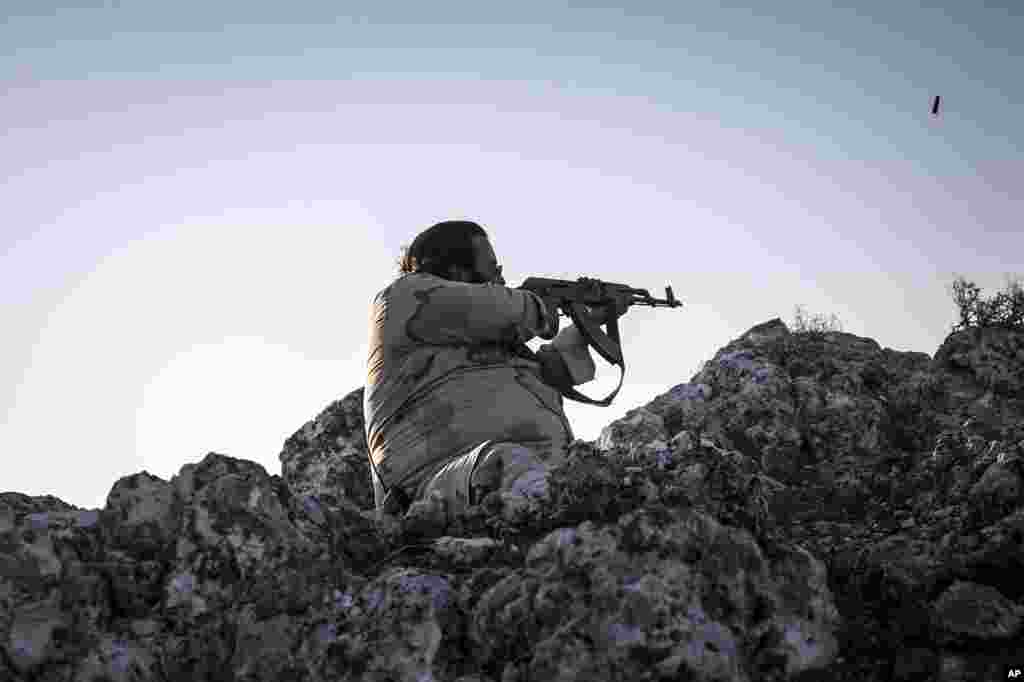 A Syrian opposition fighter aims at government forces in Telata village in Idlib province, Sept. 29. 2013.