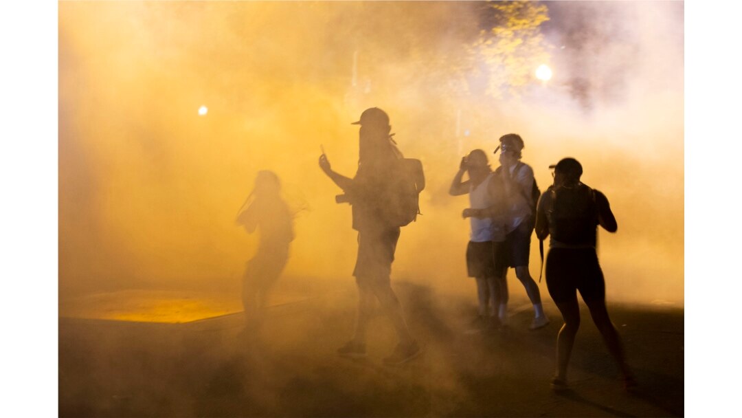 Demonstrators stand in a cloud of tear gas outside the White House on May 30, 2020 in Washington DC