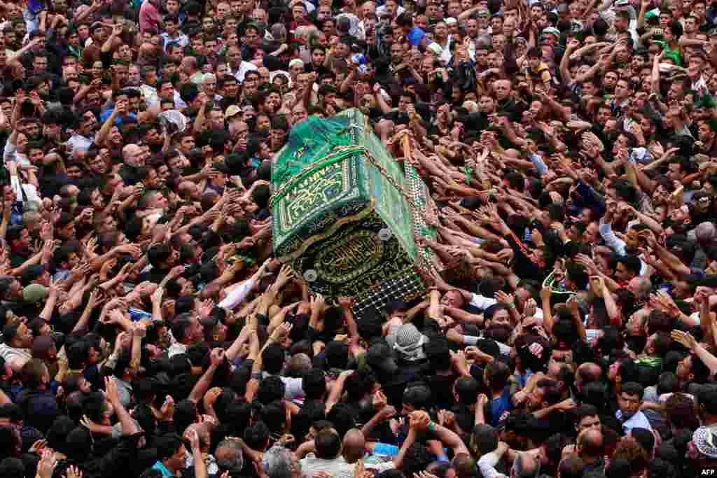 Iraqi Shi&#39;ite Muslim worshipers carry the symbolic coffin of the 8th century Imam Musa al-Kadhim during the funeral processions on the anniversary of his death at his shrine in Baghdad&rsquo;s northern district of Kadhimiya.