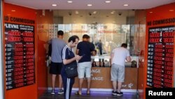 People change money at a currency exchange office in Istanbul, Turkey, Aug. 13, 2018. 