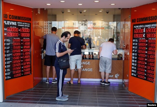 People change money at a currency exchange office in Istanbul, Turkey, Aug. 13, 2018.