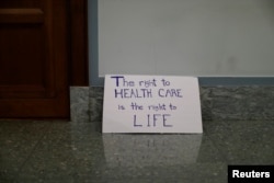 A sign is left behind after a demonstration against the latest Republican effort to repeal and replace the Affordable Care Act in Washington, Sept. 25, 2017.