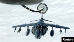 A U.S. Marines Harrier AV-8B makes its way to a fueling boom suspended from a U.S. Air Force KC-10 Extender during mid-air refueling support to Operation Inherent Resolve over Iraq and Syria air space, March 15, 2017. A U.S. airstrike is being blamed for having caused the death of 46 people in a Syrian village.