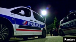 Still image taken from video shows Police vehicles at the scene near where a French police commander was stabbed to death in front of his home in the Paris suburb of Magnanville, France, June 14, 2016.