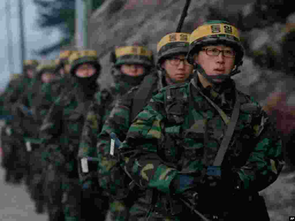 South Korean marines patrol on Yeonpyeong island, South Korea, Sunday, Dec. 19, 2010. Military maneuvers planned by South Korean troops did not take place Saturday because of bad weather on the border island shelled by North Korea last month, but the U.N.