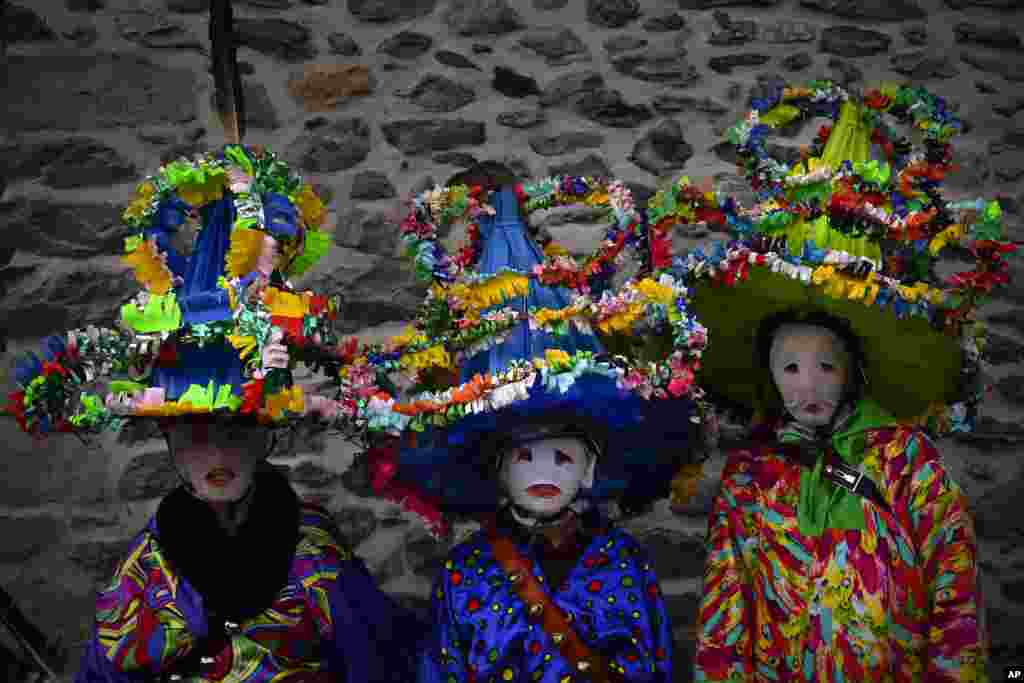 A group of participants dressed in traditional clothes and wearing large hats decorated with ribbons and feathers, known as &#39;&#39;Ttutturo&#39;&#39;, take part in the Carnival of the Pyrenees villages of Leitza, northern Spain, Jan. 30, 2018.