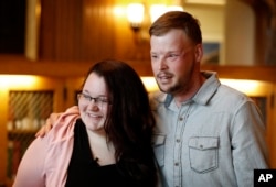 Lilly Ross, left, talks with Andy Sandness after meeting at the Mayo Clinic, Oct. 27, 2017, in Rochester, Minn. Sandness lived nearly a decade without a face.