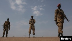 FILE - Sudan People's Liberation Army (SPLA) soldiers guard the airport in Malakal, Jan. 21, 2014. 