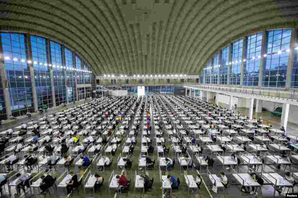 Students take a university entrance exam in a hall of the Belgrade Fair in Belgrade, Serbia.