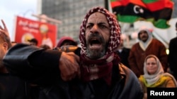 A man shouts during a demonstration against what the protesters said was the decision of the National Congress to extend the period of their stay in power, in Benghazi December 27, 2013.