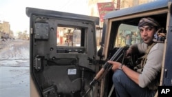 Tribal fighter sits in Humvee during joint patrol with Iraqi security forces in Ramadi, 70 miles (115 kilometers) west of Baghdad, Jan. 30, 2014.