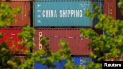 FILE - Shipping containers, including one labelled "China Shipping," are stacked at the Paul W. Conley Container Terminal in Boston, Massachusetts, May 9, 2018. 