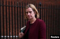 FILE - Britain's Home Secretary Amber Rudd leaves 10 Downing Street in London, April 10, 2018.