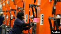 A BMW employee works on the door assembly for the X4 at the BMW manufacturing plant in Spartanburg, South Carolina.