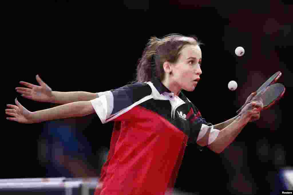 Neli Shoifer of Israel serves to Delgermaa Mergen of Mongolia in the women's single qualifying rounds at the World Team Table Tennis Championships in Paris, France.