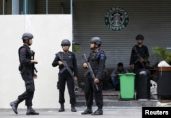 FILE - Indonesian police stand guard at the site of this week's militant attack in central Jakarta, Indonesia, Jan. 16, 2016.