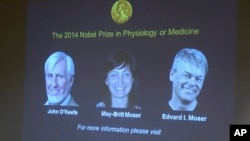 Images of the winners of the 2014 Nobel Prize for Medicine, U.S.-British scientist John O'Keefe and Norwegian husband and wife Edvard Moser and May-Britt Moser are projected on a screen during the announcement in Stockholm Monday Oct. 6, 2014.