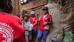 Red Cross volunteers talk to villagers about the plague outbreak, 30 miles west of Antananarivo, Madagascar, Oct. 16, 2017.