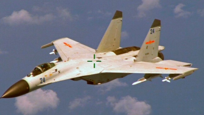 FILE - A U.S. military official says two Chinese J-11 fighters, like one pictured here, flew out to intercept a U.S. EP-3 Aries aircraft, coming so close that they forced the pilot to descend a couple hundred feet.