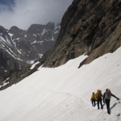 Rangers in Rocky Mountain National Park, Colorado, crossing the snowfield on Longs Peak on the way to Chasm Lake