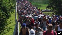 FILE - Migrants arrive in Villa Comaltitlan, Chiapas state, Mexico, Oct. 27, 2021, as they continue their journey through Mexico to the U.S. border. 