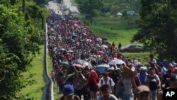 FILE - Migrants arrive in Villa Comaltitlan, Chiapas state, Mexico, Oct. 27, 2021, as they continue their journey through Mexico to the U.S. border.