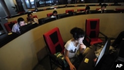 FILE - People use computers at an internet cafe in Hefei, Anhui province, China.